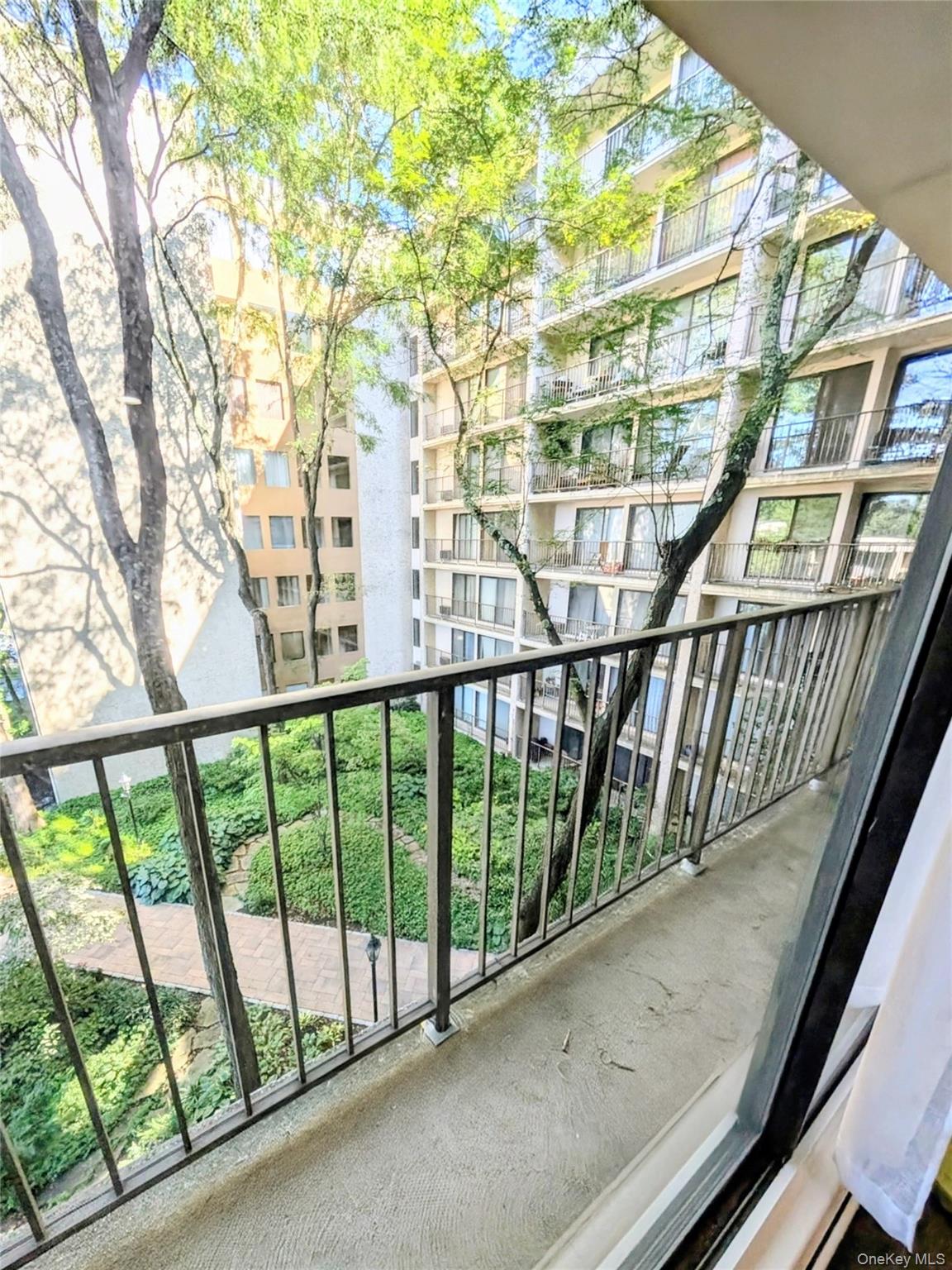 150 Overlook Avenue, Unit 4L Peekskill, NY 10566 - Photo 29 of 32 a view of balcony with large trees and wooden stairs