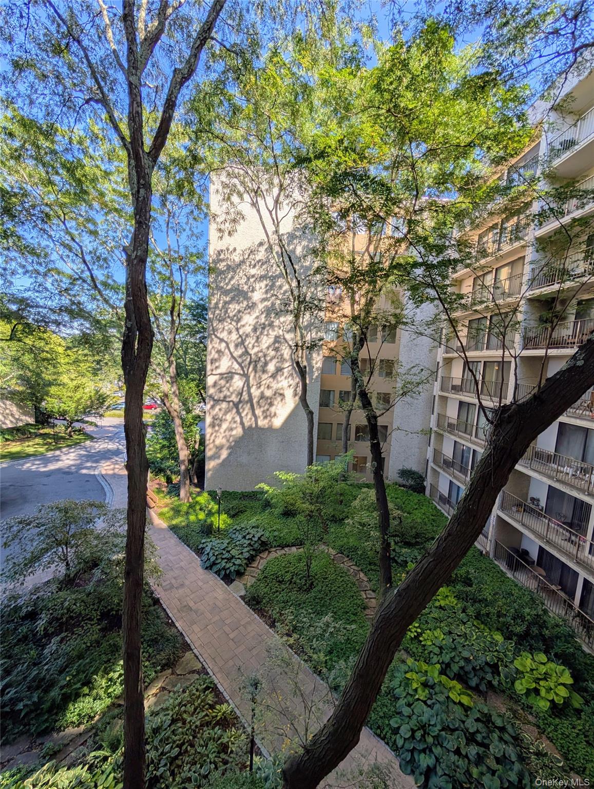 150 Overlook Avenue, Unit 4L Peekskill, NY 10566 - Photo 30 of 32 a view of a garden with plants and trees