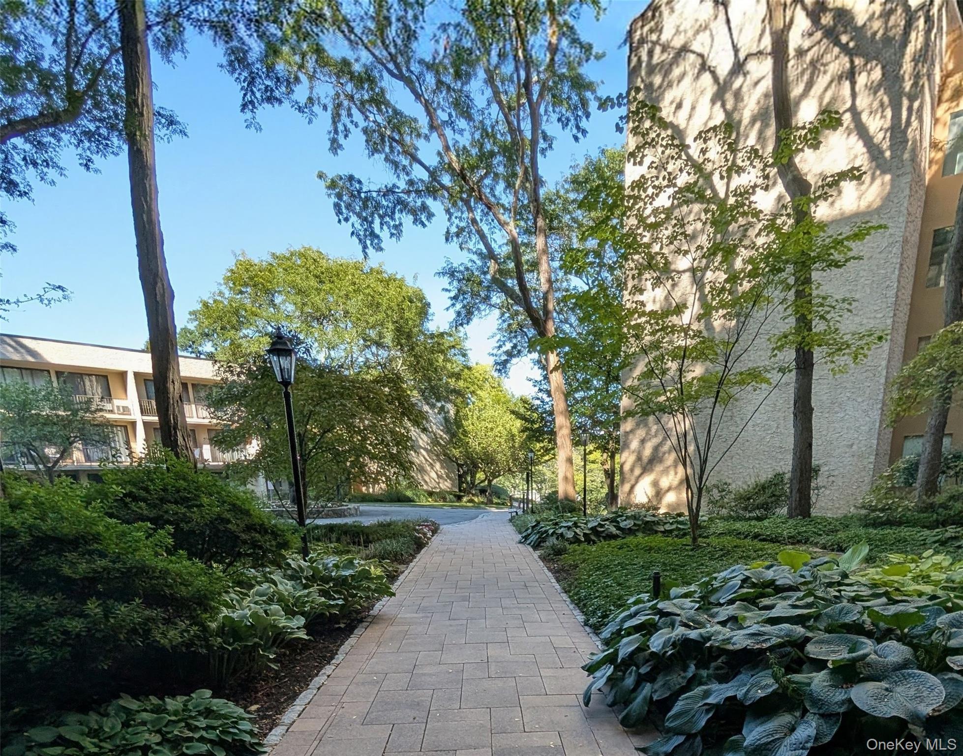 150 Overlook Avenue, Unit 4L Peekskill, NY 10566 - Photo 3 of 32 a front view of a house with a yard and fountain in middle