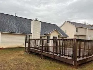 a view of a house with wooden floor roof and wooden fence