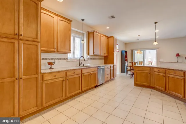 a large kitchen with stainless steel appliances lots of counter top space and cabinets