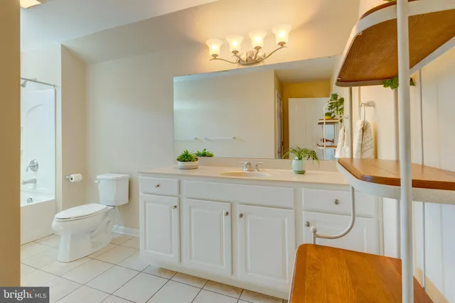 a spacious bathroom with a double vanity sink mirror and toilet