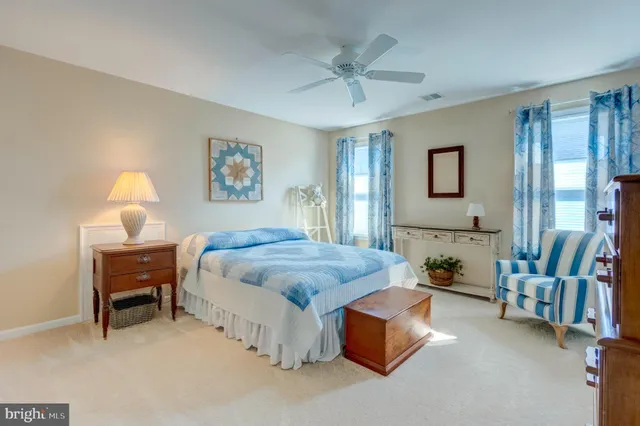 a spacious bedroom with a bed and a chandelier