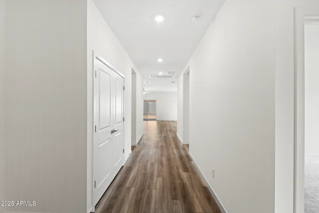a view of a hallway with wooden floor