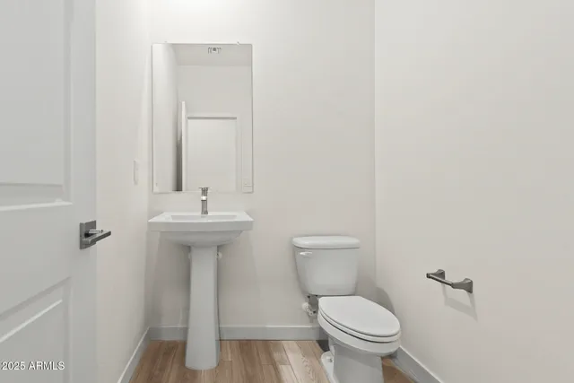a view of a room with a window and wooden floor