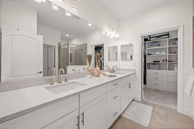 a bathroom with a sink double vanity and a mirror