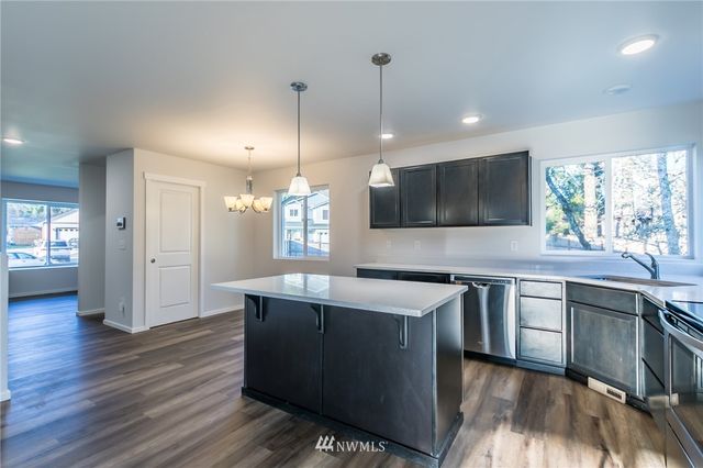 a kitchen with a sink stove and microwave