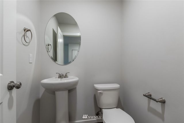 a view of an empty room with closet and a window