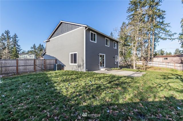 a view of a yard with large trees