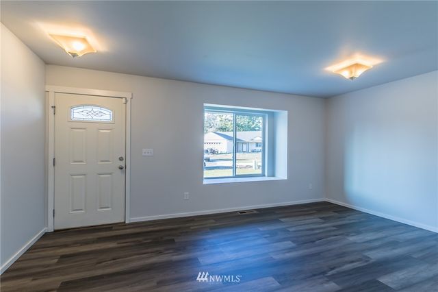 a view of a room with wooden floor and brick walls