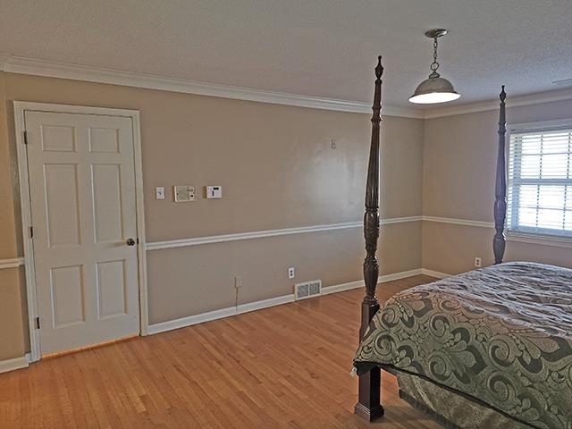 2040 Ridgeway Road Memphis, TN 38119 - Photo 16 of 35 a bedroom with a bed and a chandelier