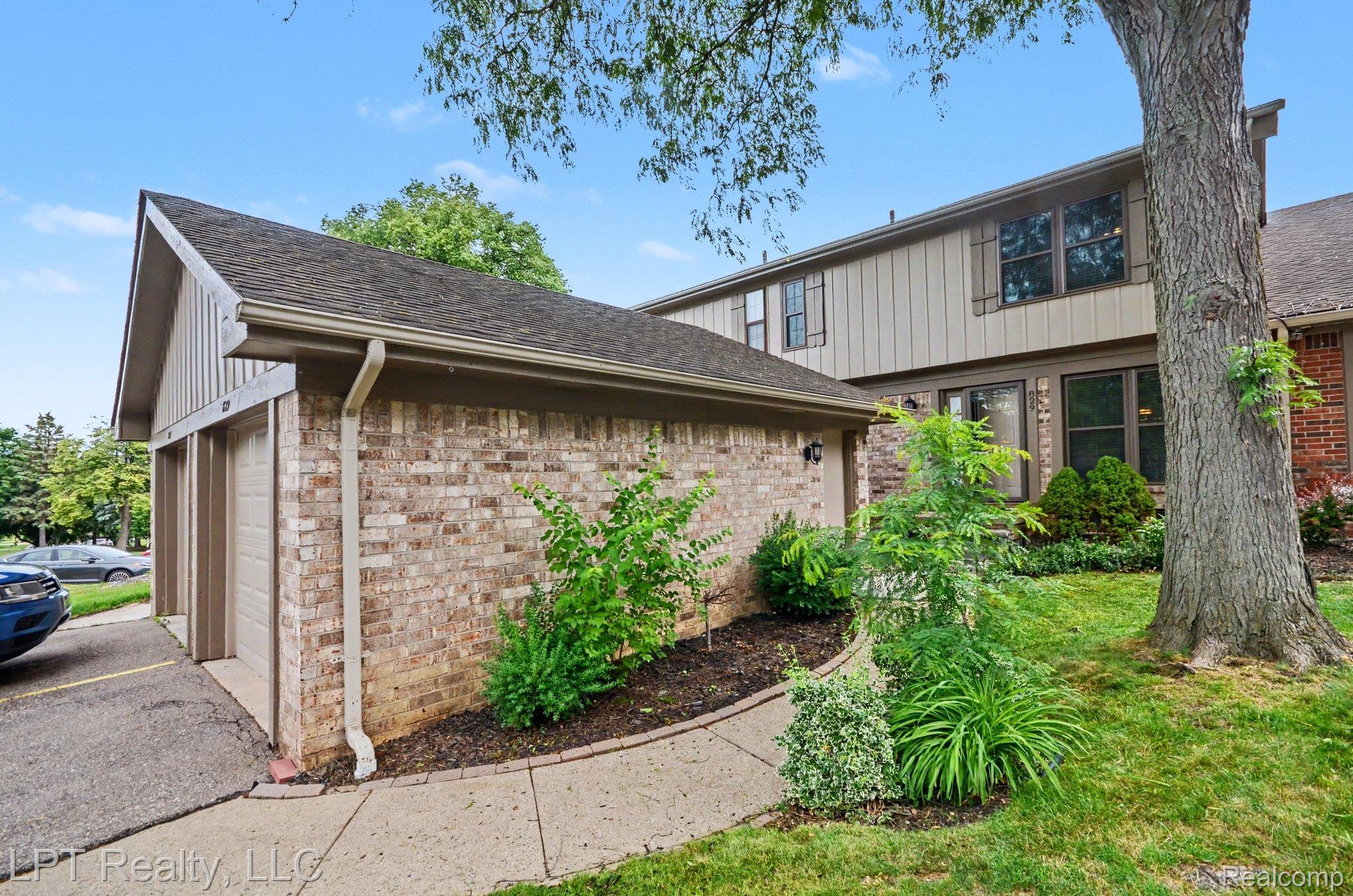 829 Langdon Court Rochester, MI 48307 - Photo 27 of 31 Brick and vertical siding exterior with a shingled roof