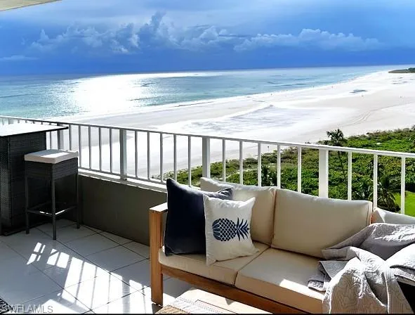 a roof deck with couches and wooden floor