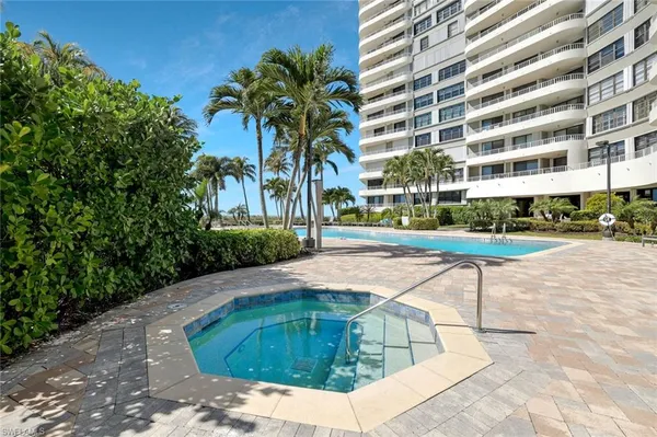 a view of a swimming pool with a lounge chair