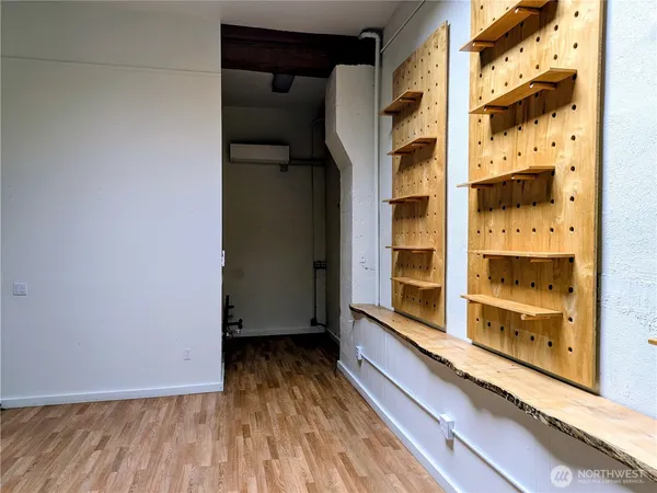 a view of a room with wooden floor and windows