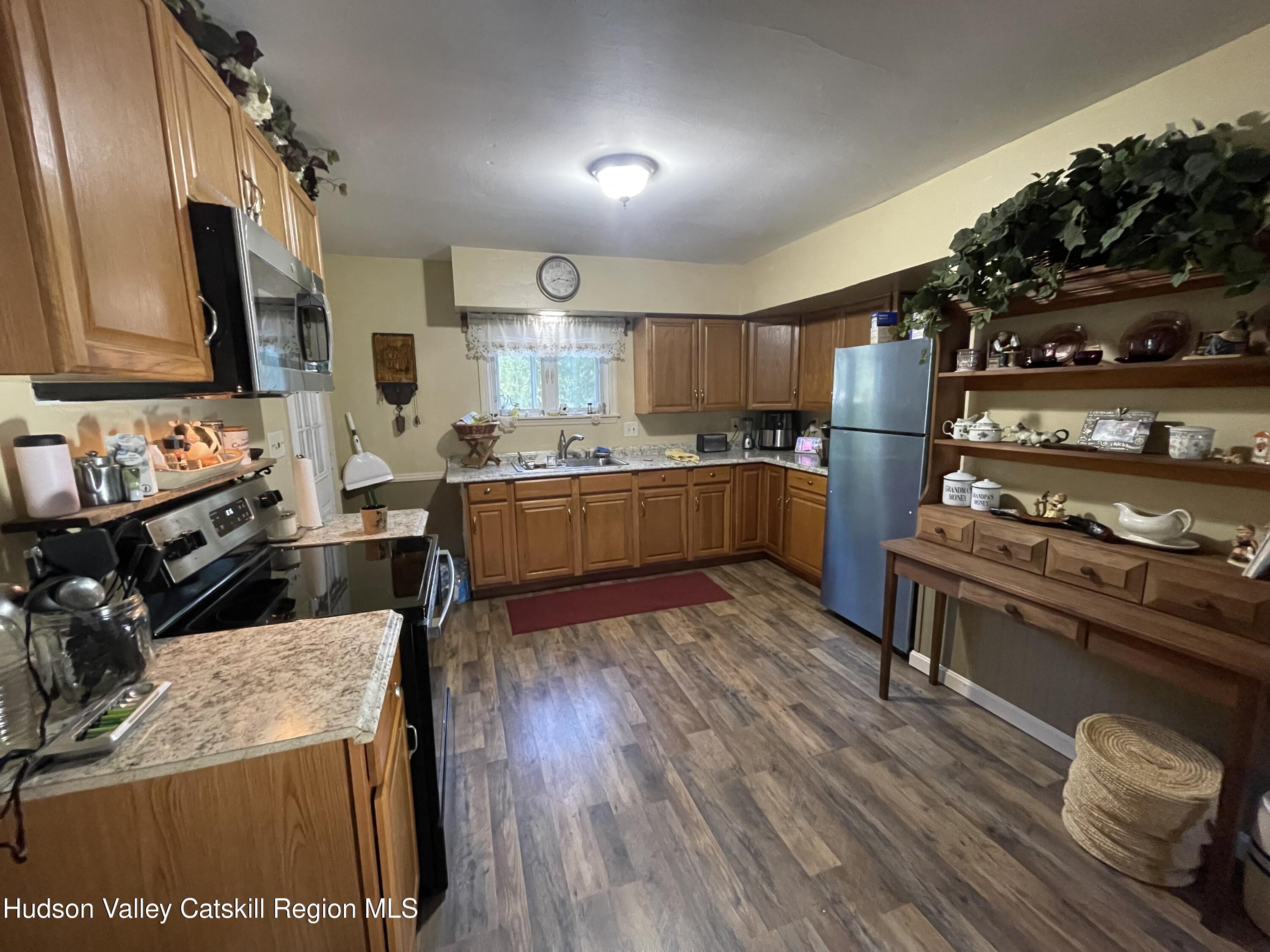10 Johns Road Kerhonkson, NY 12446 - Photo 7 of 30 a kitchen with wooden floors and stainless steel appliances