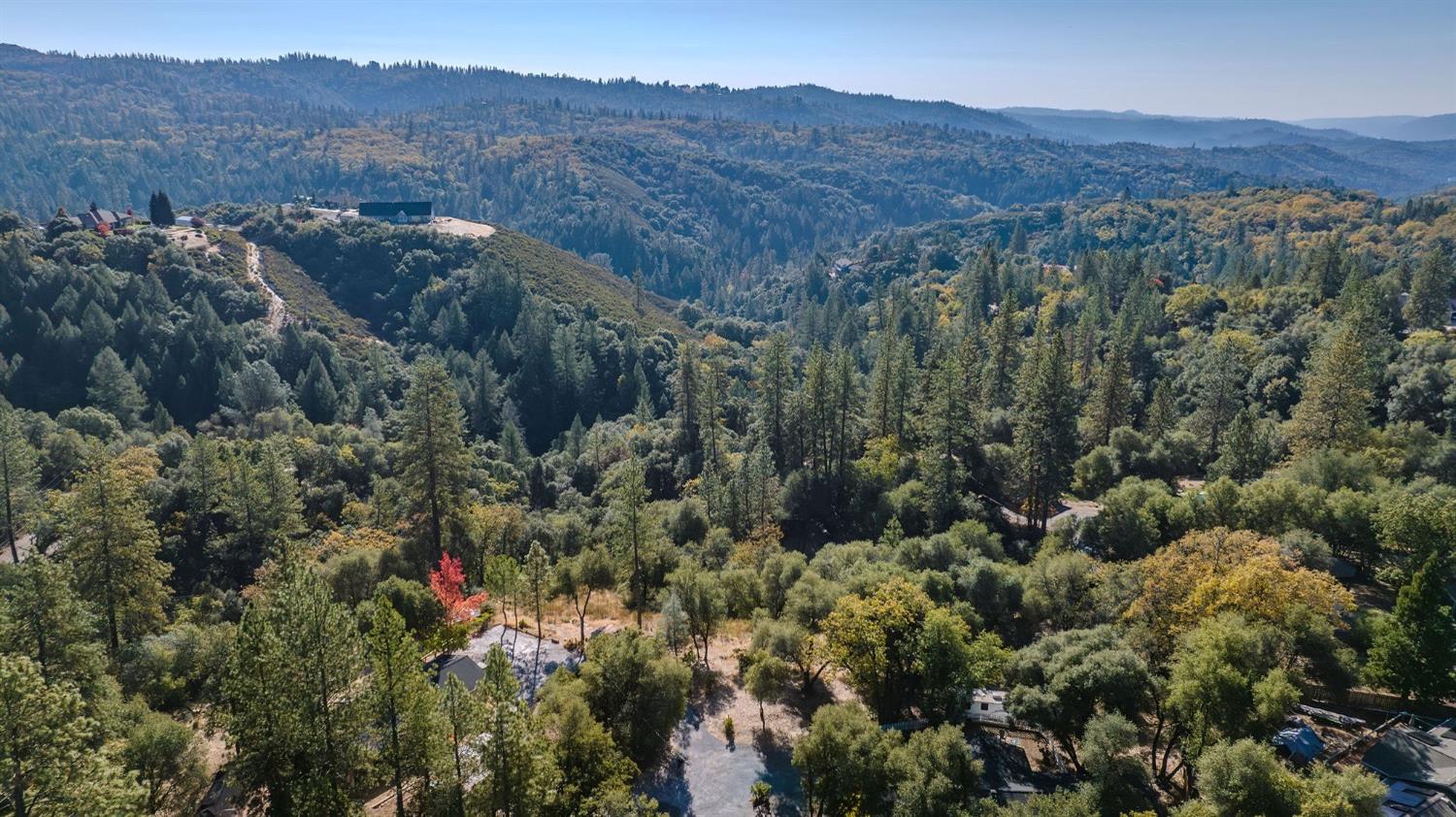 5793 Forest Lake Road Diamond Springs, CA 95619 - Photo 25 of 27 a view of a lush green hillside and a building