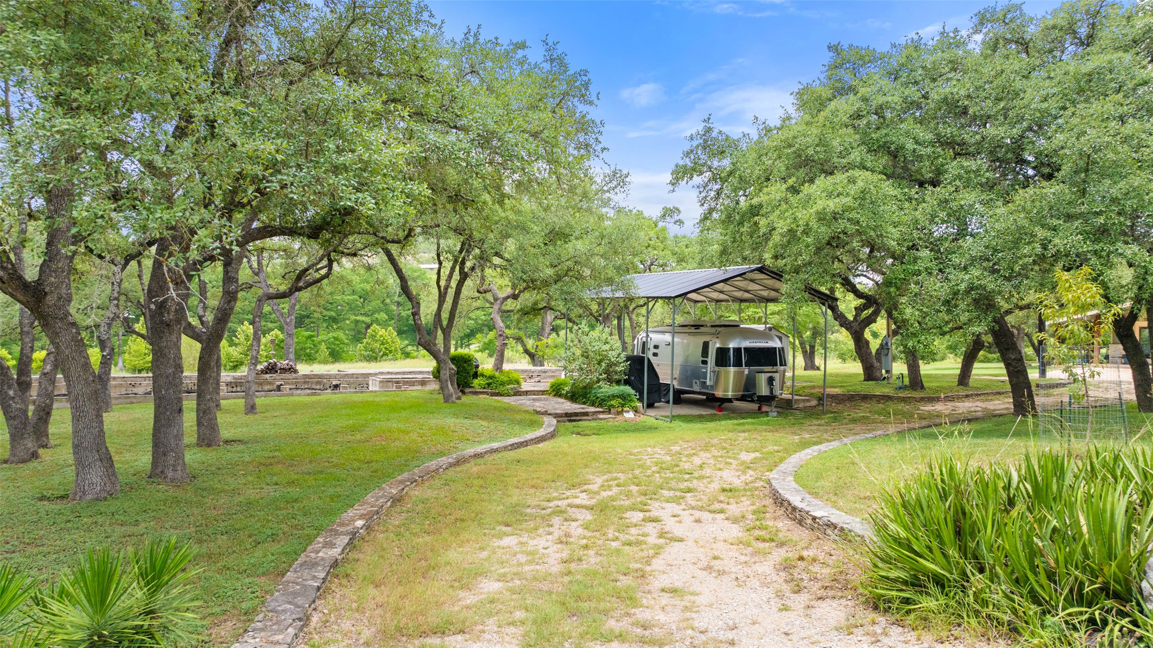 200 Rim Road Wimberley, TX 78676 - Photo 11 of 25 a view of a swimming pool and trees in the background
