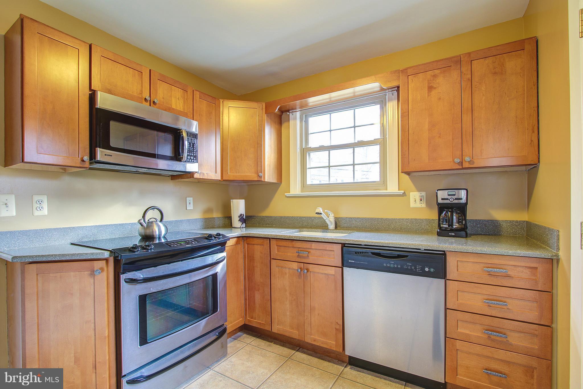 8008 Piney Branch Road Silver Spring, MD 20910 - Photo 8 of 22 a kitchen with granite countertop cabinets stainless steel appliances a sink and a window