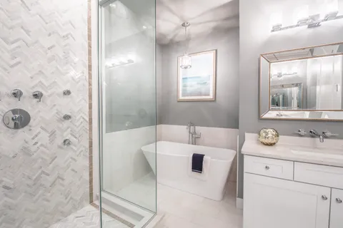 a bathroom with a sink a vanity a mirror and a shower