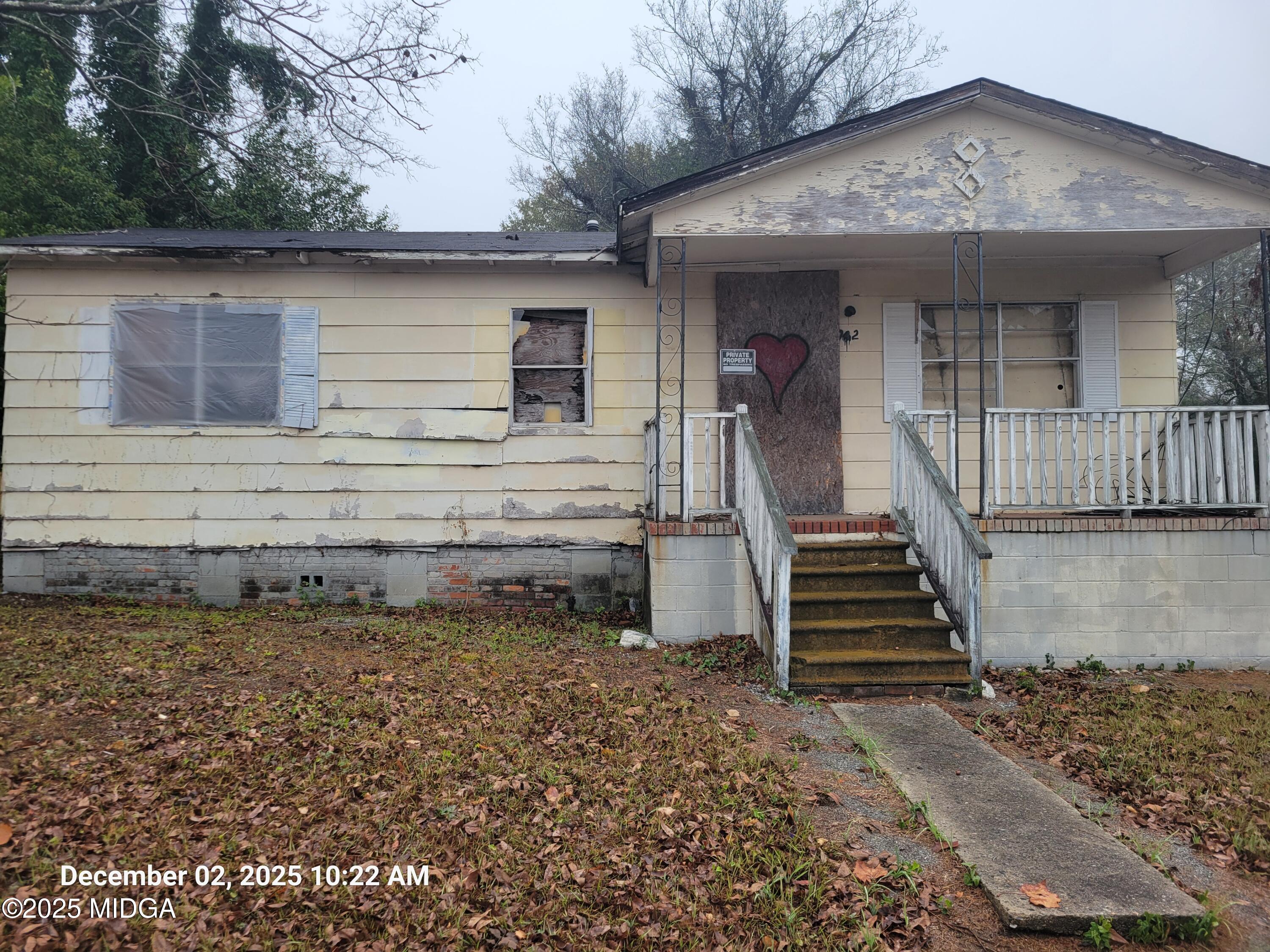 1942 Walnut Street Macon, GA 31201 - Photo 3 of 6 a view of a house with a small yard and wooden floor and fence