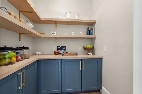 a kitchen with a sink a stove and cabinets