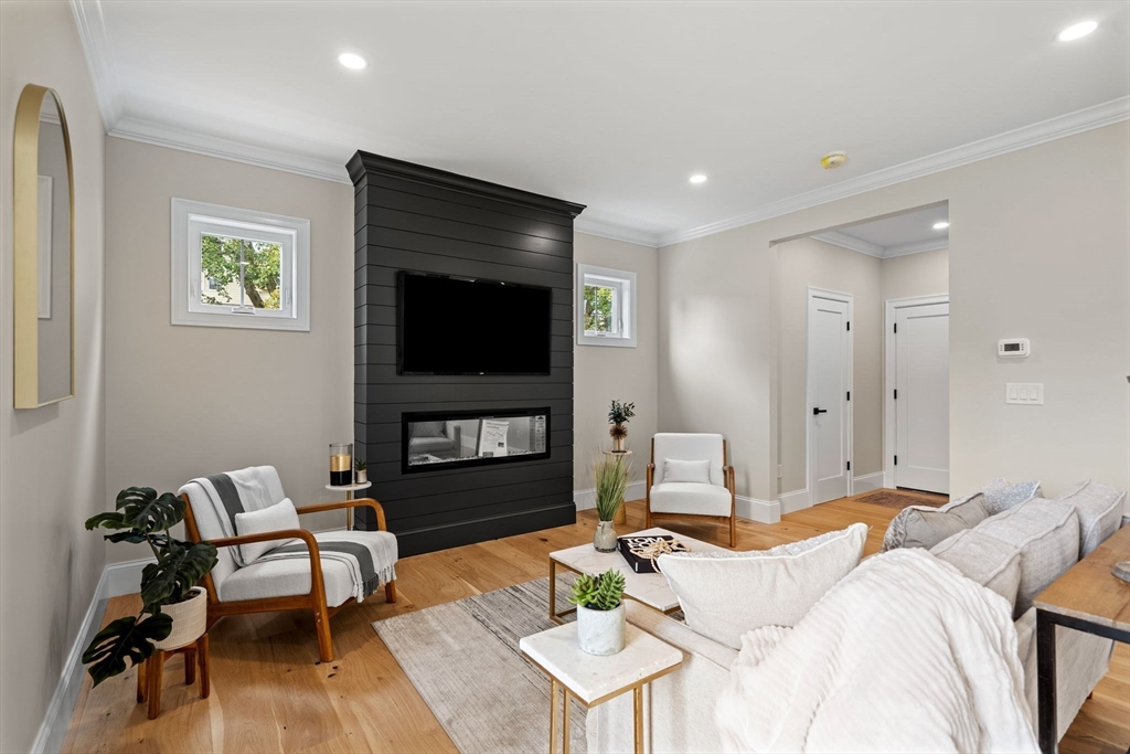 61 Mt Pleasant Street Woburn, MA 01801 - Photo 13 of 39 a living room with furniture and a flat screen tv