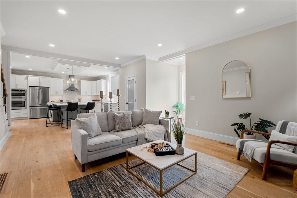 61 Mt Pleasant Street Woburn, MA 01801 - Photo 14 of 39 a living room with furniture kitchen view and a table