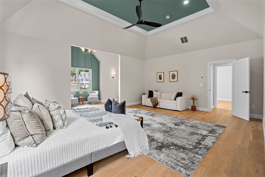 61 Mt Pleasant Street Woburn, MA 01801 - Photo 18 of 39 a bedroom with a bed and wooden floor