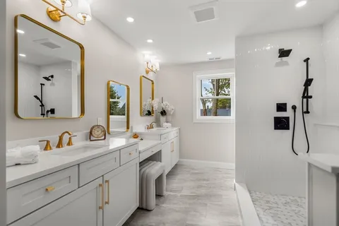 a bathroom with a double vanity sink a mirror and shower
