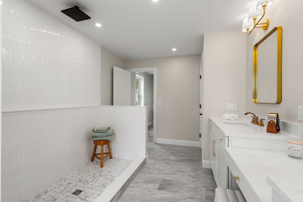 61 Mt Pleasant Street Woburn, MA 01801 - Photo 25 of 39 a bathroom with a sink and a mirror