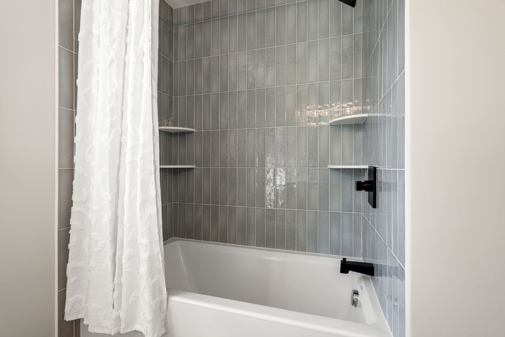61 Mt Pleasant Street Woburn, MA 01801 - Photo 27 of 39 a bathroom with a bathtub