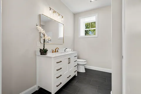 a bathroom with a double vanity sink and mirror