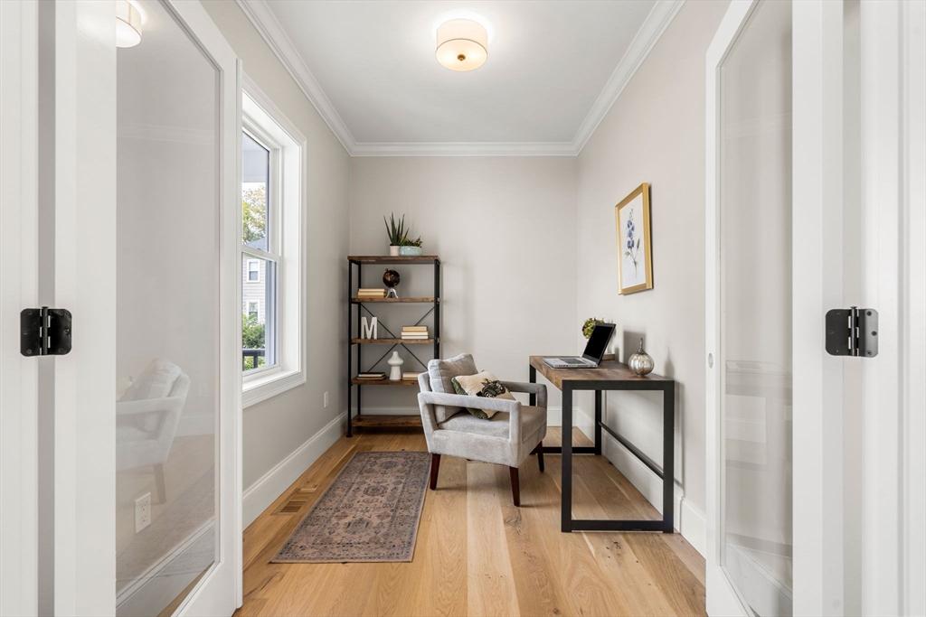 61 Mt Pleasant Street Woburn, MA 01801 - Photo 4 of 39 a living room with furniture and a wooden floor