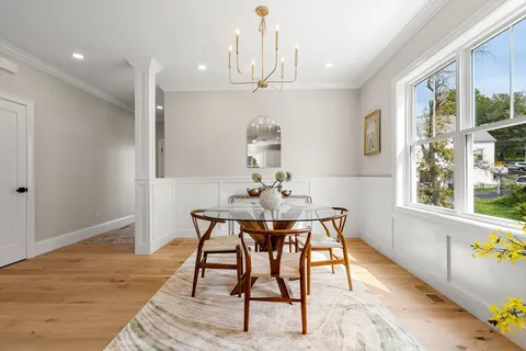 a view of a dining room with furniture window and wooden floor