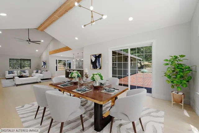 a front view of a house with a yard and potted plants