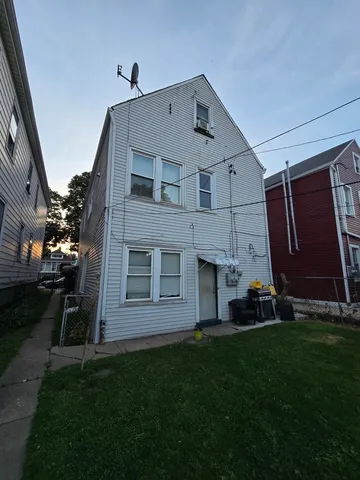 a aerial view of a house next to a yard