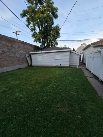 a view of backyard with seating area and green space