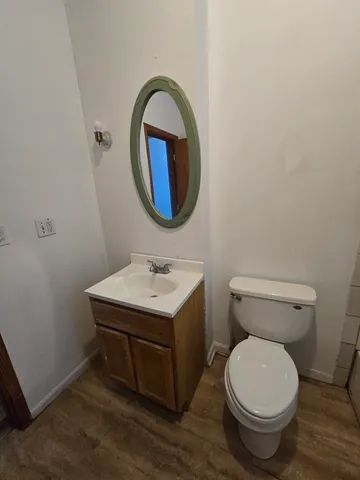 a bathroom with a toilet a sink and a mirror
