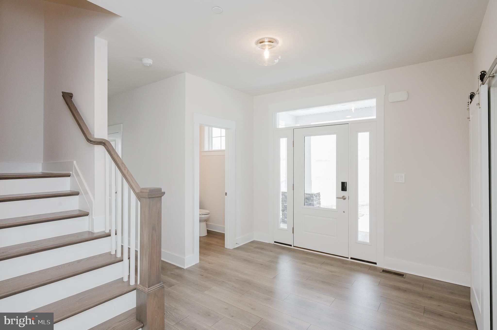 1605 A Oakland Road Freeland, MD 21053 - Photo 19 of 32 a view of entryway with wooden floor and stairs