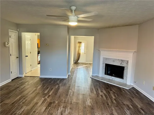 wooden floor fireplace and natural light in room