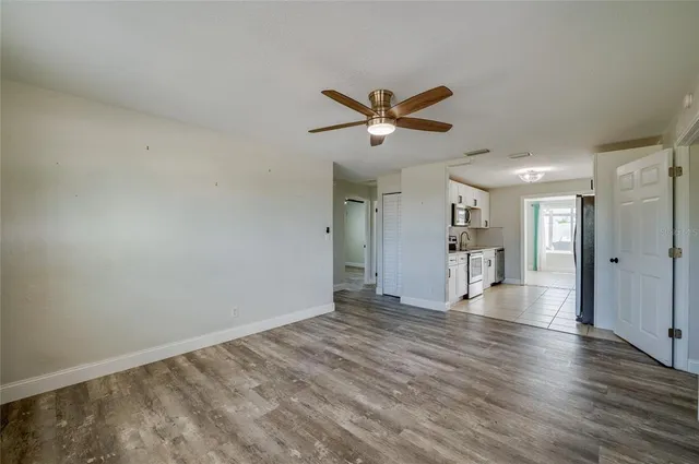 a kitchen with white cabinets and appliances
