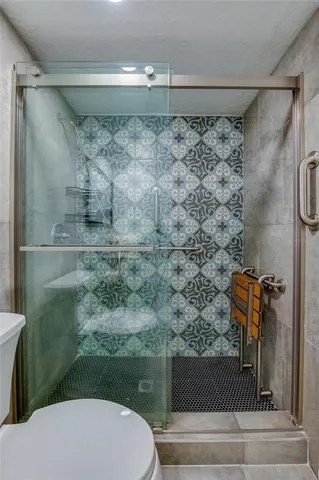 a bathroom with a toilet sink and shower