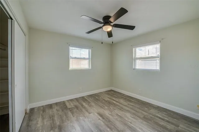 a living room with patio furniture and a chandelier