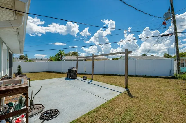 a view of a patio with a table and chairs
