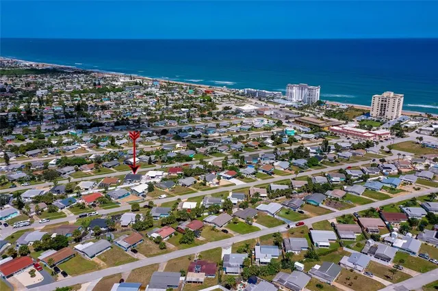a view of empty room with wooden floor and ceiling fan