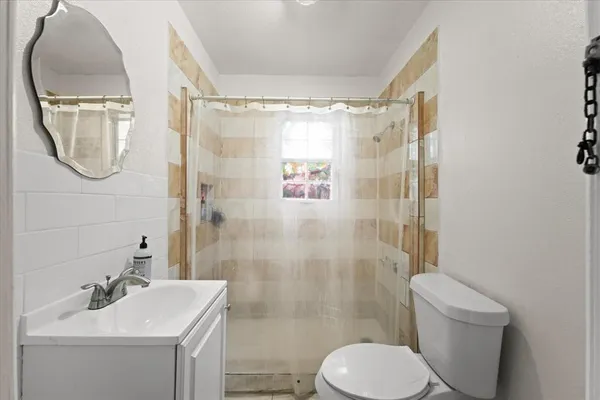 a bathroom with a sink toilet and shower