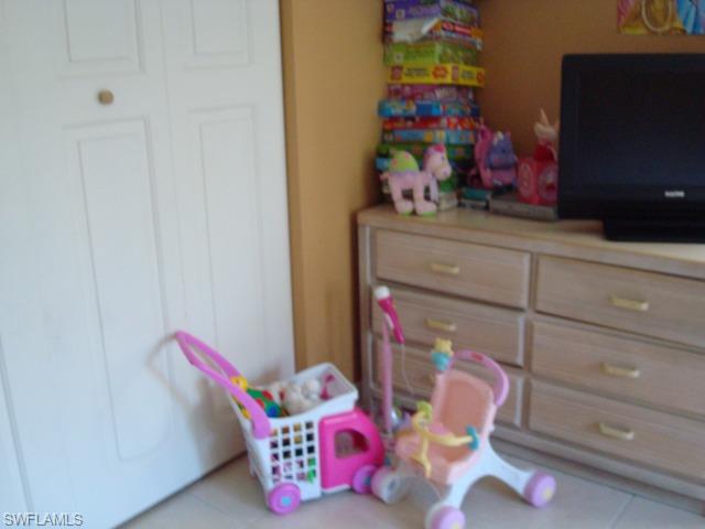 1205 Creech Road Naples, FL 34103 - Photo 9 of 10 a room with toys and storage