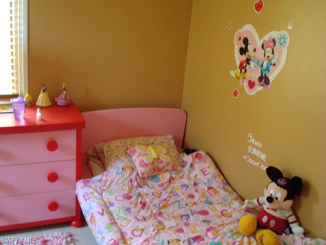 1205 Creech Road Naples, FL 34103 - Photo 10 of 10 a bedroom with a bed and a dresser