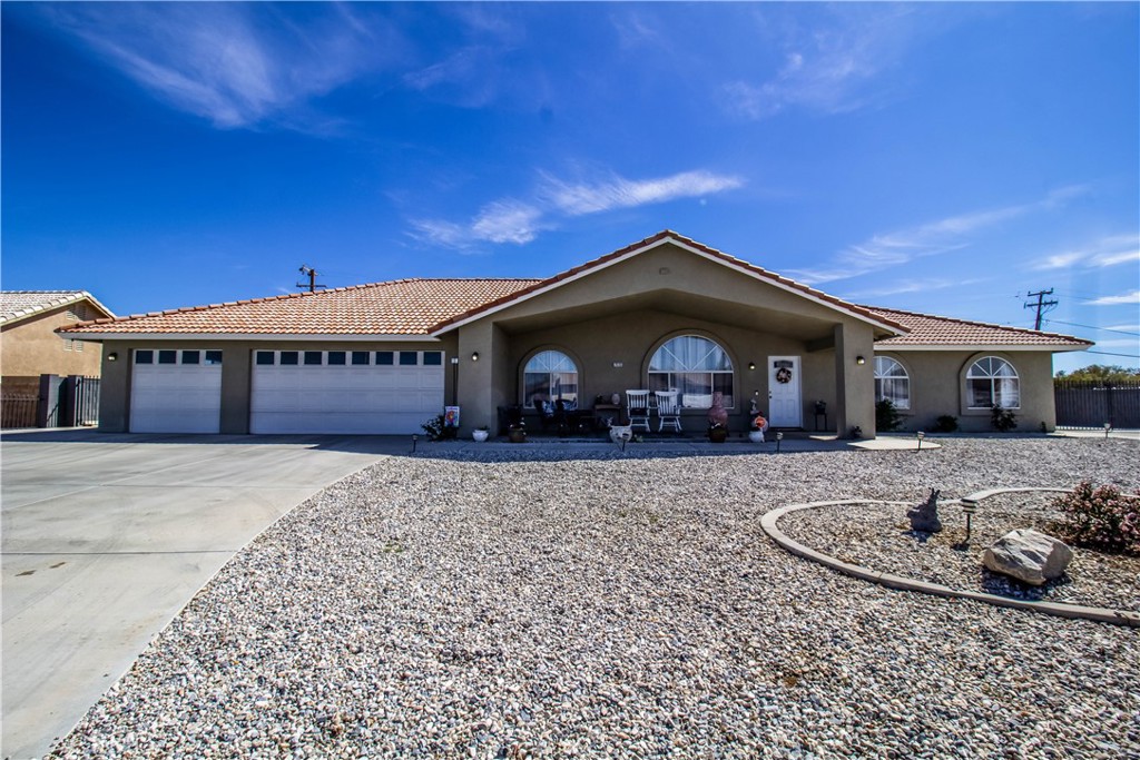20293 Osuna Road Apple Valley, CA 92307 - Photo 1 of 1 a front view of a house with a yard